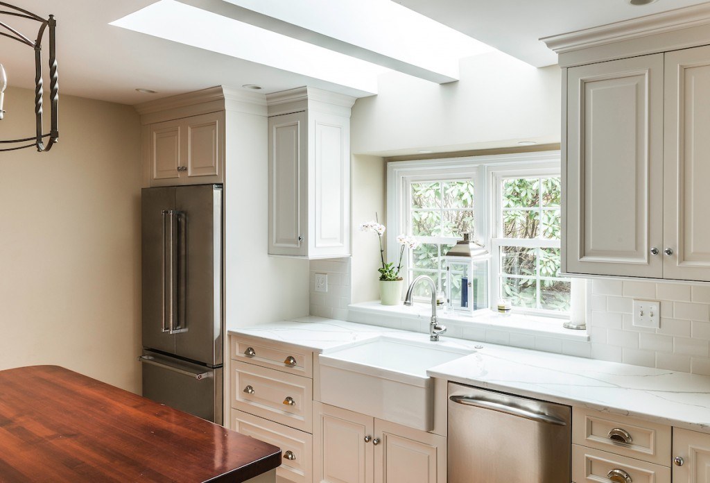 Wayne white country kitchen wide angle with island in foreground and range wall beyond