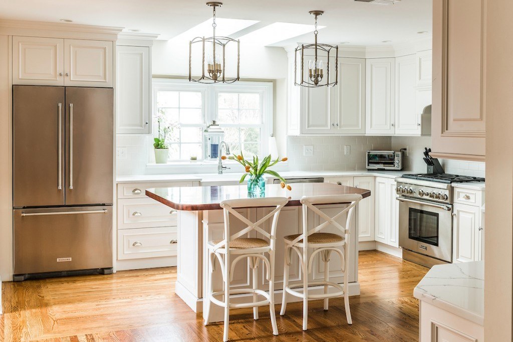 White country kitchen with raised-panel frameless cabinets, Cambria quartz counters, edge-grain butcher-block island, and a shiplap accent wall in Wayne, PA — kitchen remodel by Fedor Fabrication