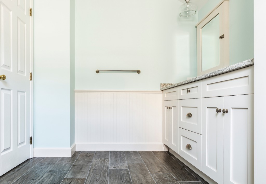 Tall white linen tower beside double vanity in West Chester, PA bathroom remodel — Coastal seafoam primary
