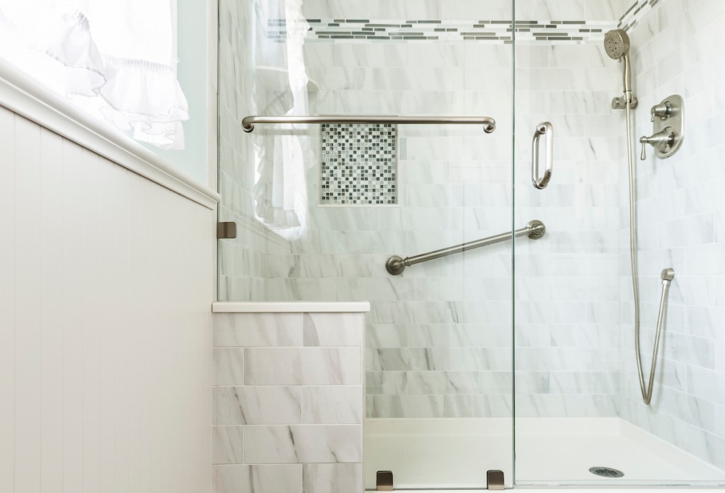 White Carrara marble subway shower with blue glass mosaic accent in West Chester, PA bathroom remodel — Coastal seafoam primary