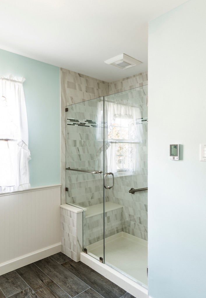 Marble subway shower with niche and grab bar in West Chester, PA bathroom remodel — Coastal seafoam primary