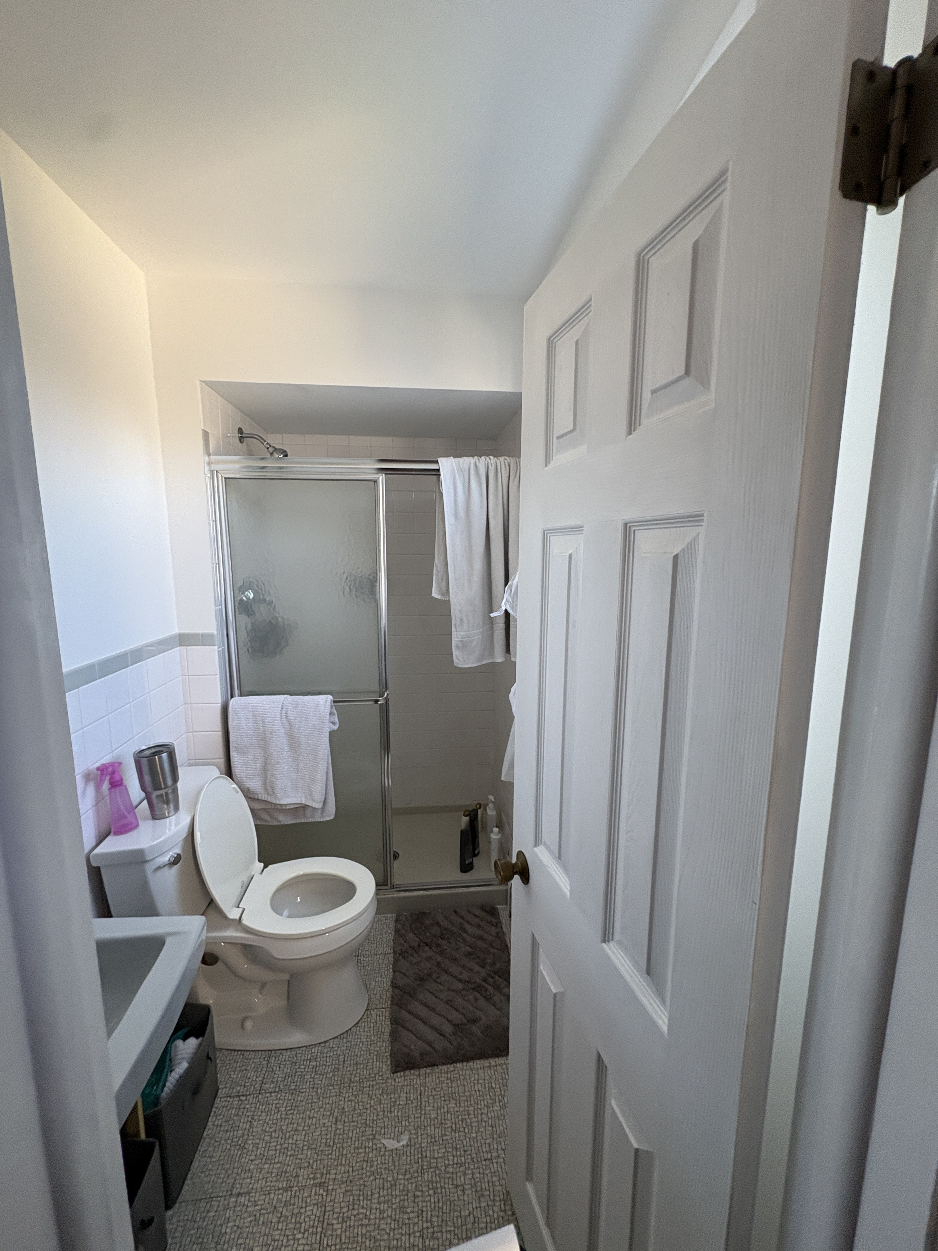 Original West Chester primary bathroom — coffered drop ceiling, sliding-door tub/shower, beige textured wall, before remodel