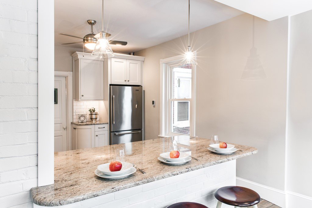 Borough Victorian kitchen with painted brick wall and white Shaker cabinetry in West Chester, PA — kitchen remodel by Fedor Fabrication