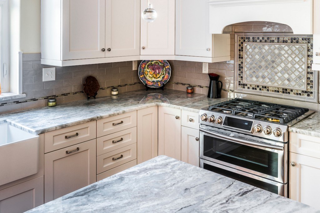 West Chester kitchen view showing the fireclay farmhouse sink under the window and decorative plate display