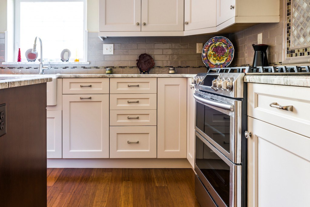 West Chester kitchen detail showing the mustard soffit accent above the white perimeter cabinets