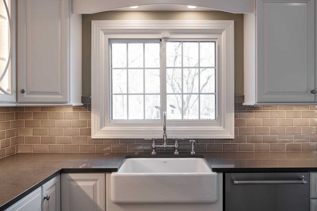 West Chester twist-on-white kitchen view across the island toward the dining room opening