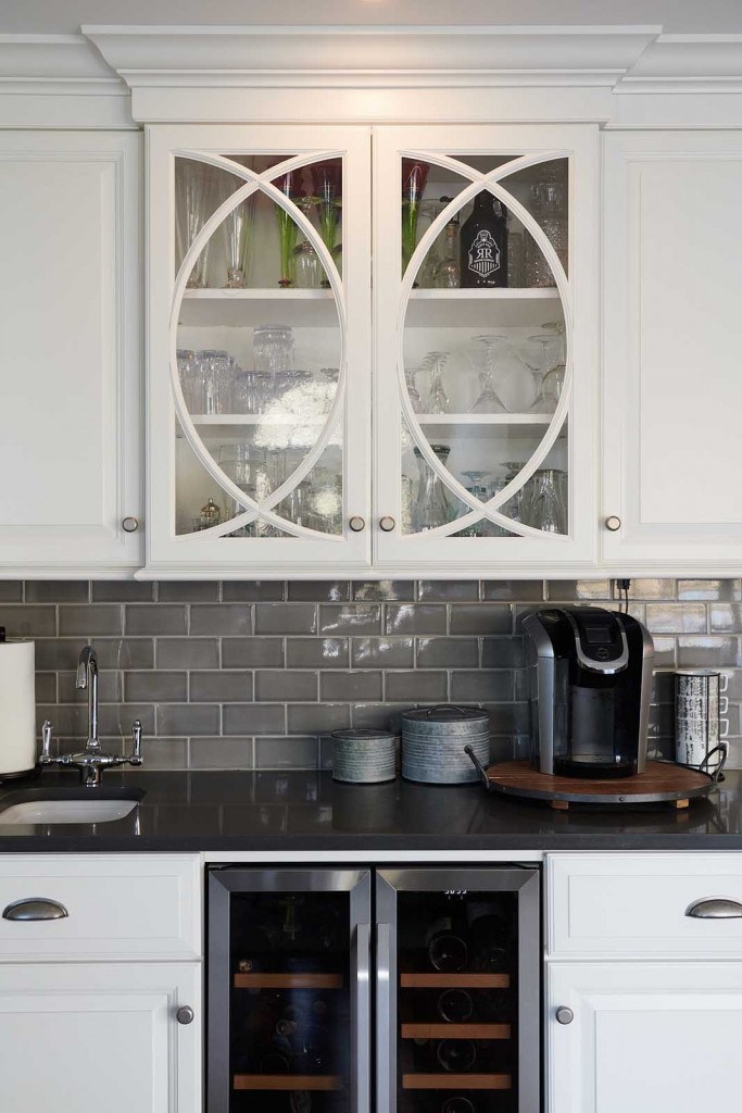 West Chester kitchen looking at the range wall with custom hood and pewter herringbone metal accent backsplash