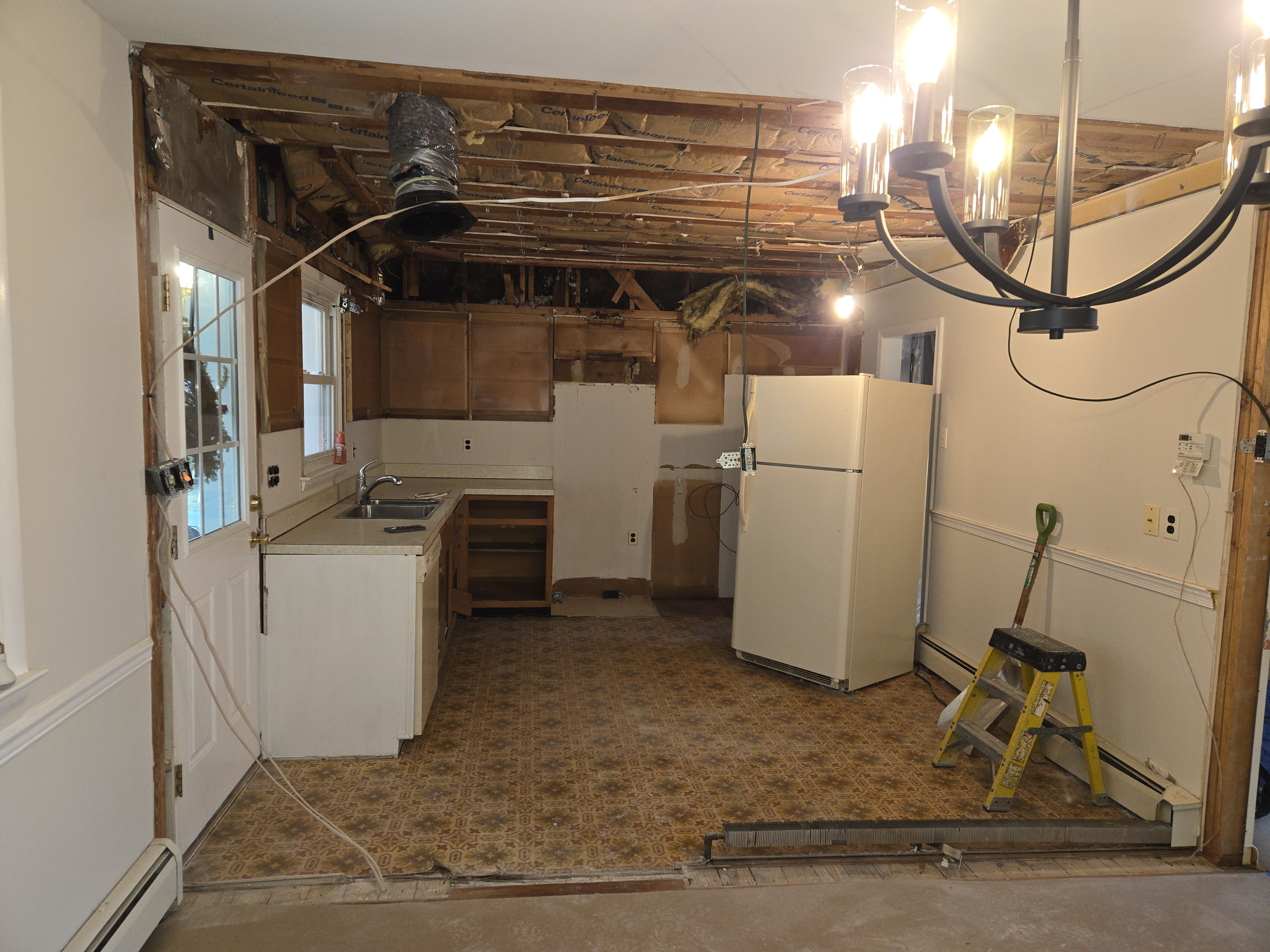 Demo in progress — drop ceiling pulled and old cabinets being removed in the West Chester kitchen remodel