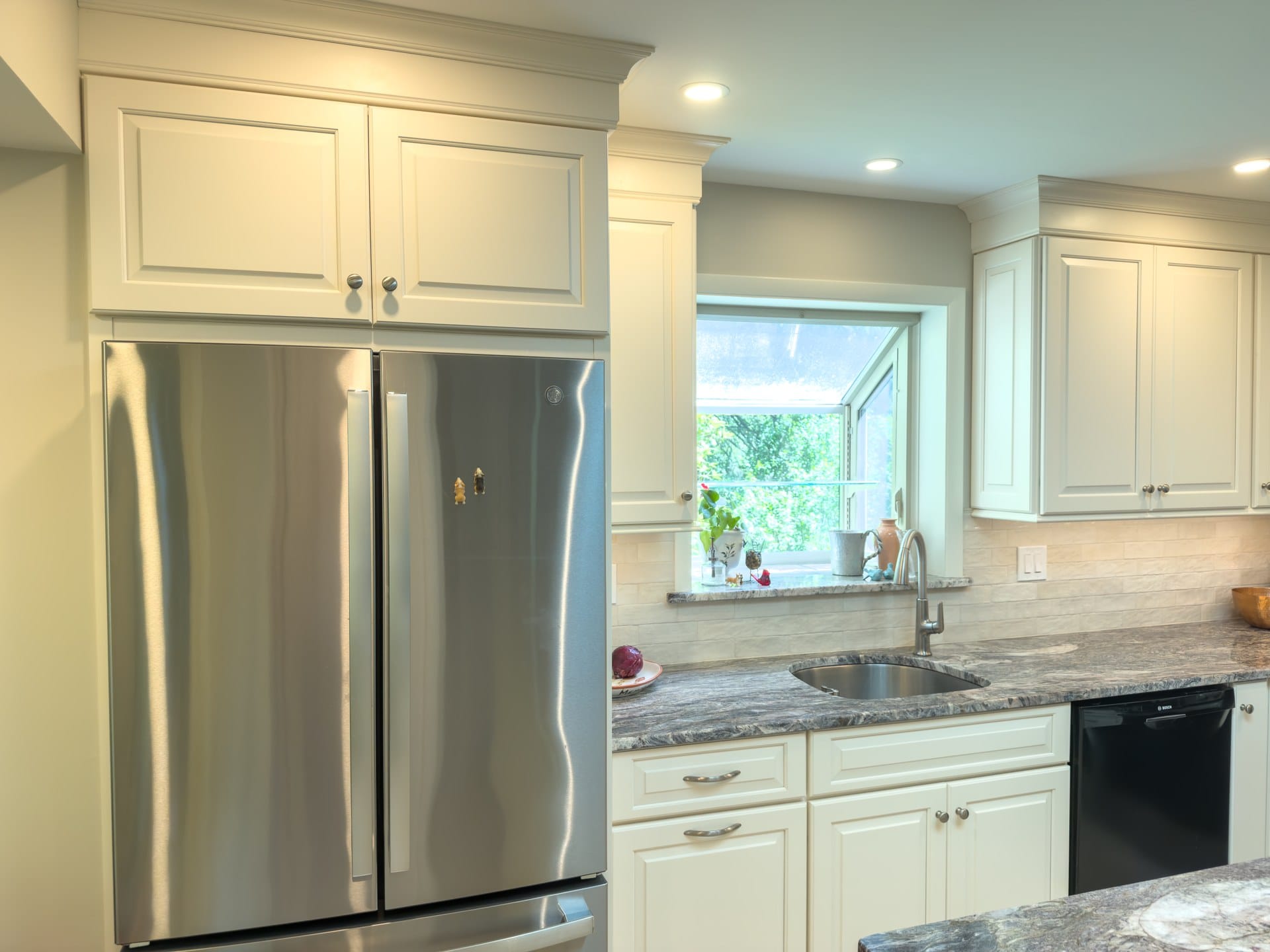 Stainless refrigerator and granite counters in a remodeled Chester Springs kitchen