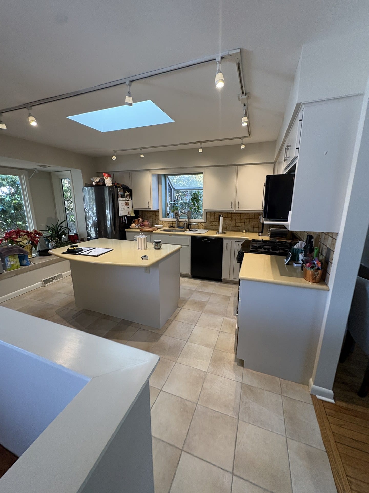 Dated Chester Springs kitchen before remodeling with almond cabinets, dropped soffit, and track lighting