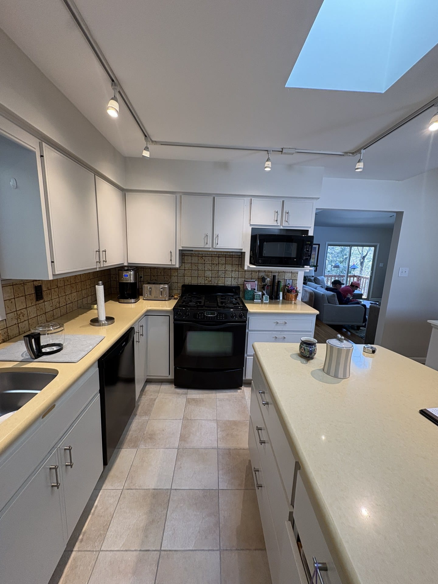 Before photo of Chester Springs kitchen showing the old range, microwave, and laminate counters