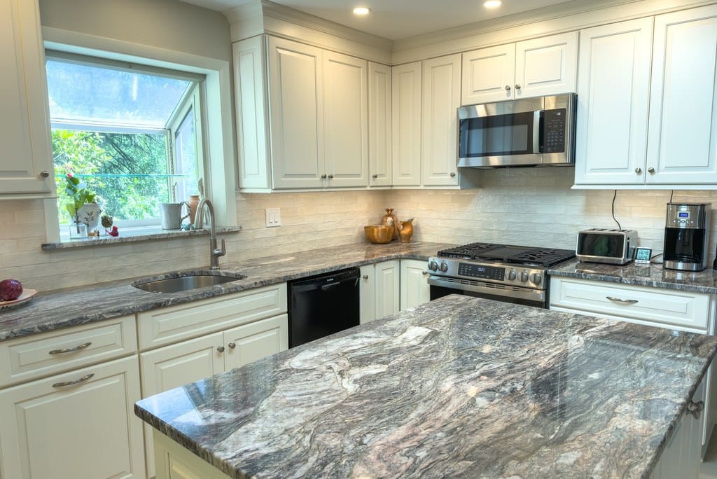 Dramatic granite kitchen remodel with custom-cream Shiloh cabinetry in Chester Springs, PA by Fedor Fabrication