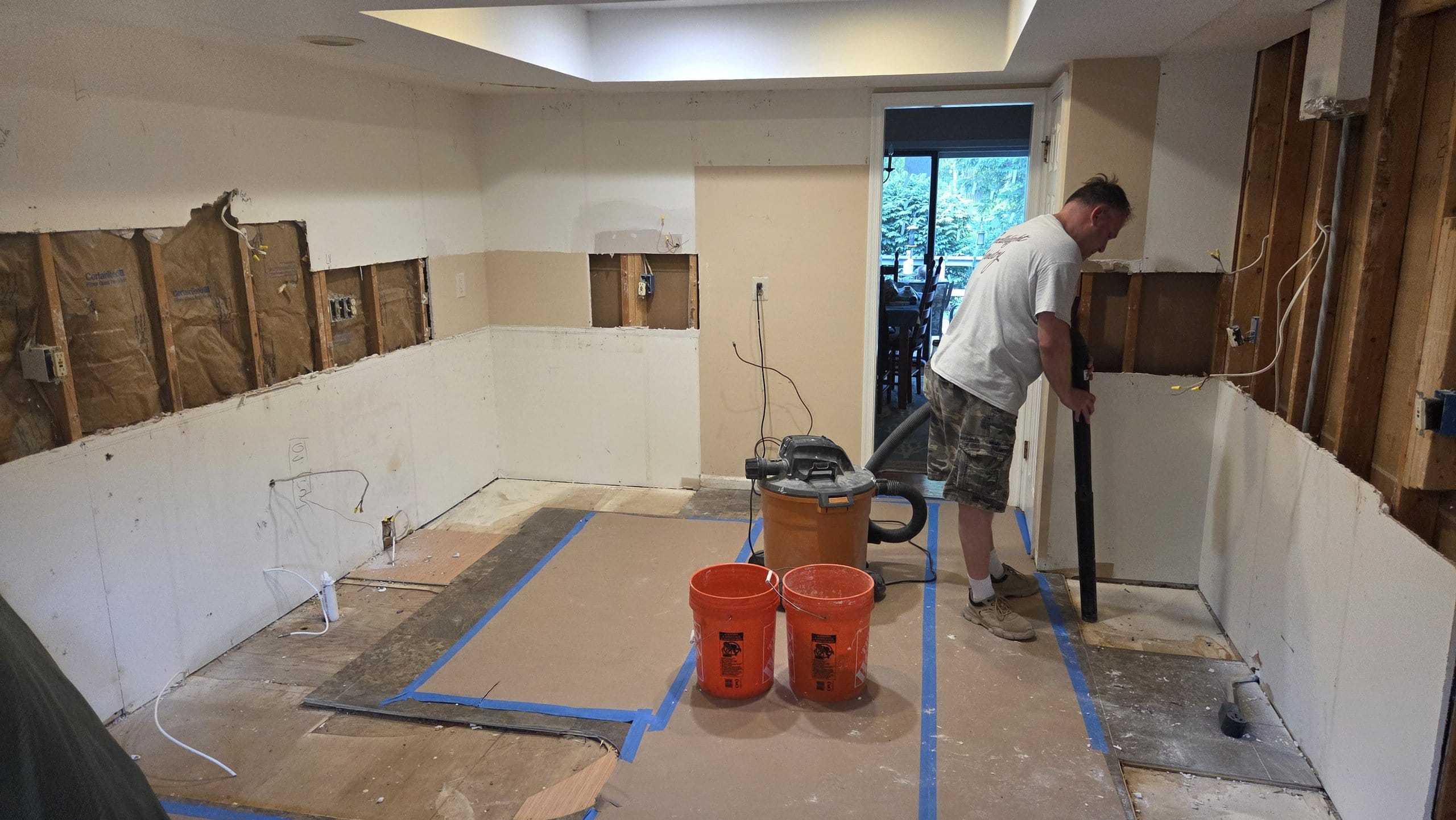 Kitchen during construction with cabinets removed and walls prepped